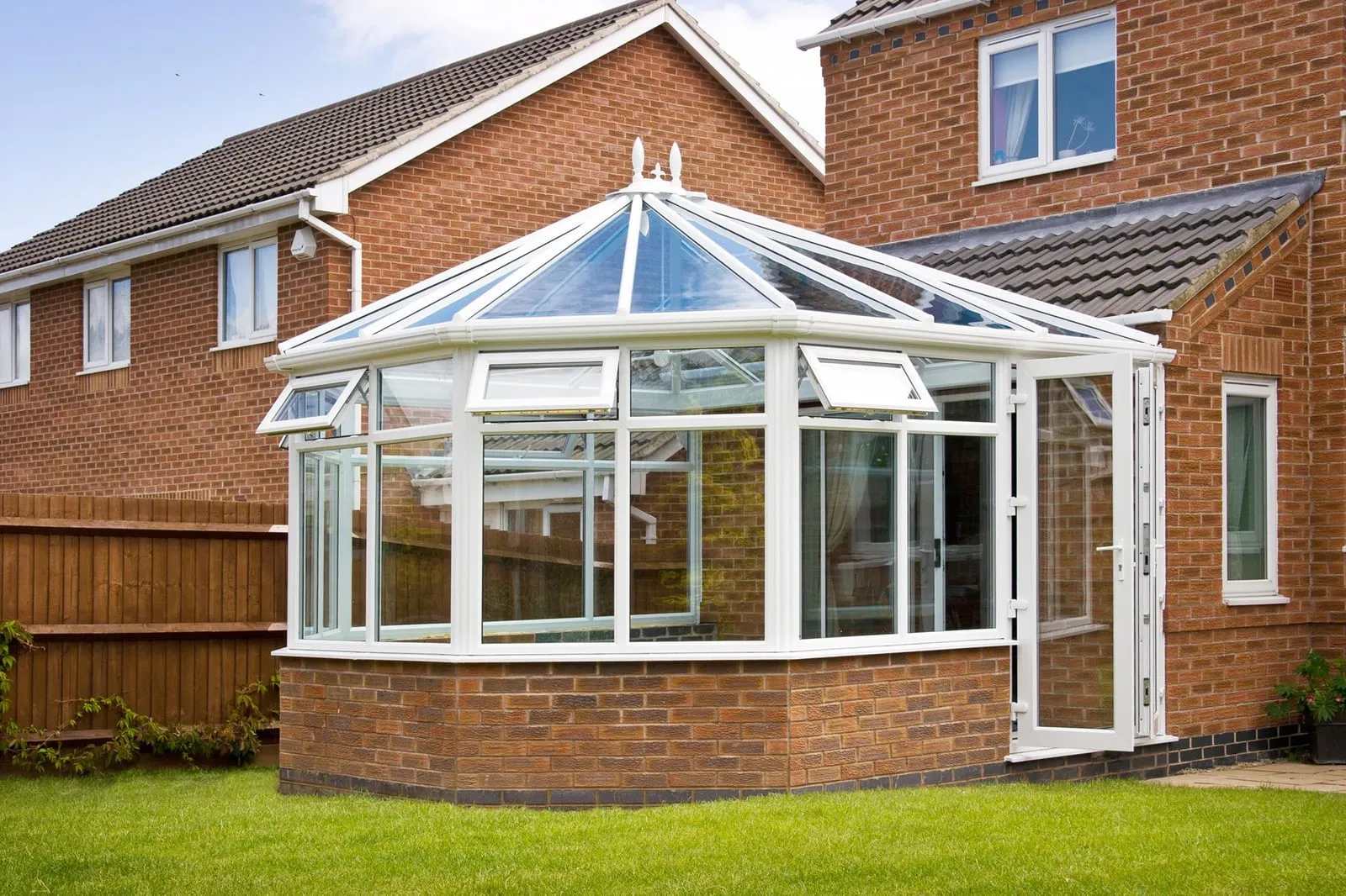White uPVC conservatory with glass roof built onto a brick house Everglaze Window Solutions Portsmouth