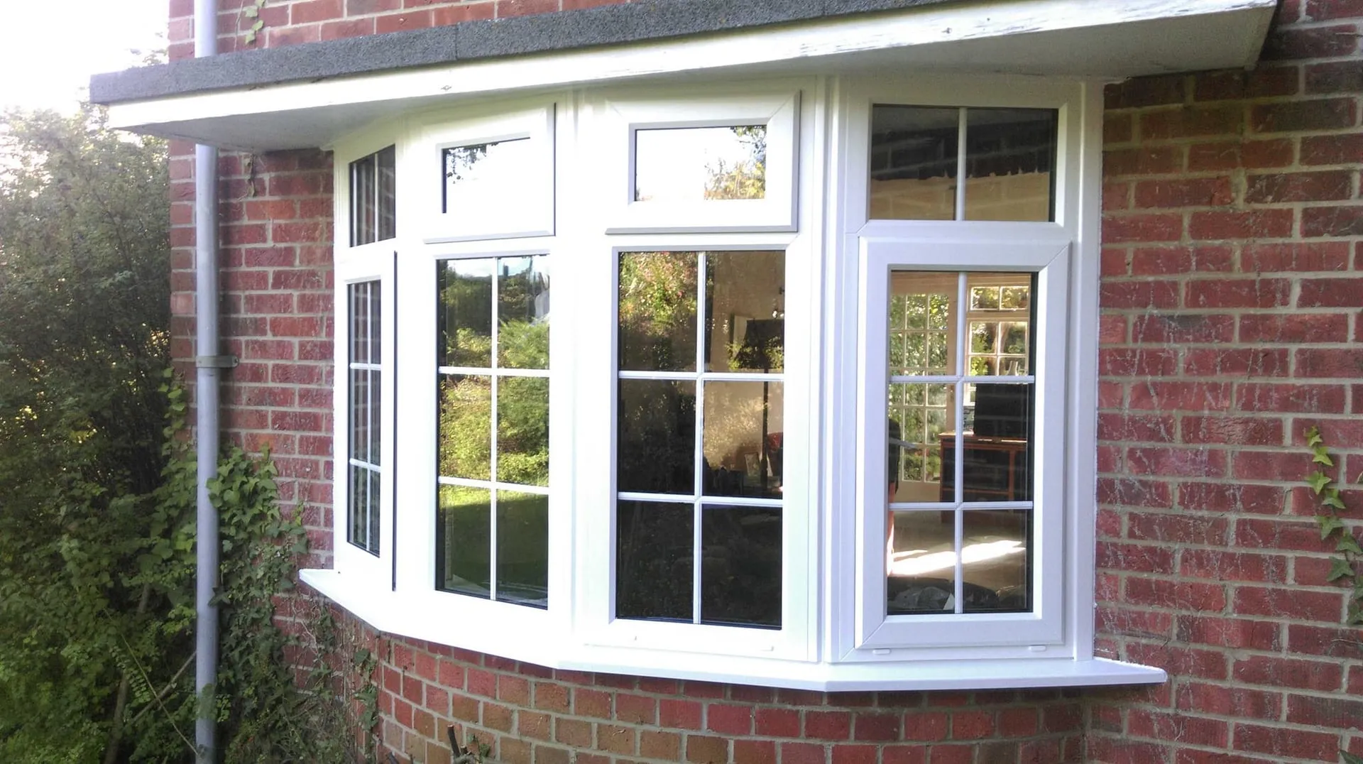 White uPVC double glazed bay window fitted to a red brick house by Everglaze Window Solutions Portsmouth